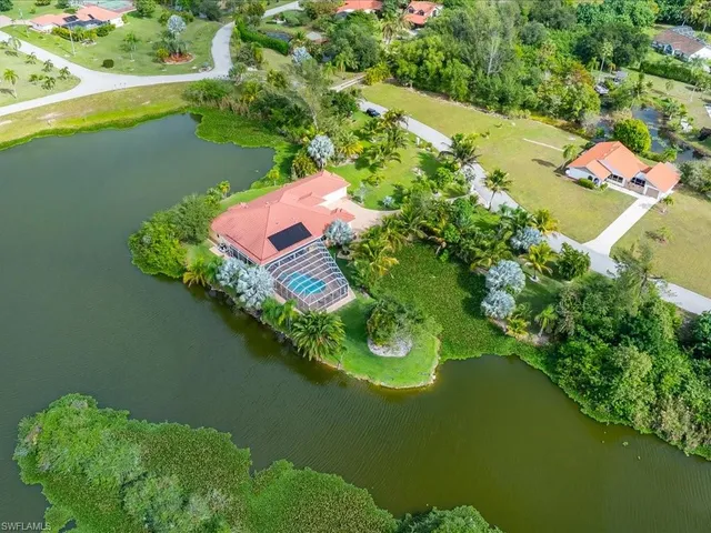 an aerial view of a house with a lake view