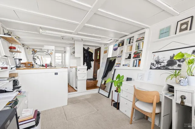 a living room with furniture and a clock
