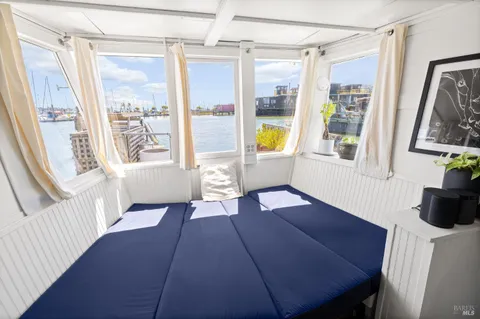a view of a livingroom with furniture wooden floor and windows