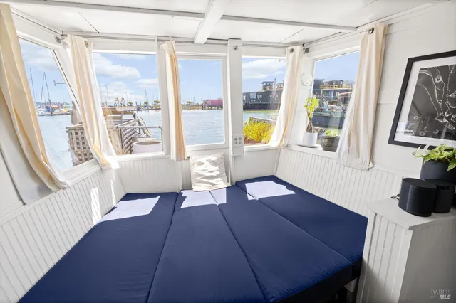 a view of a livingroom with furniture wooden floor and windows