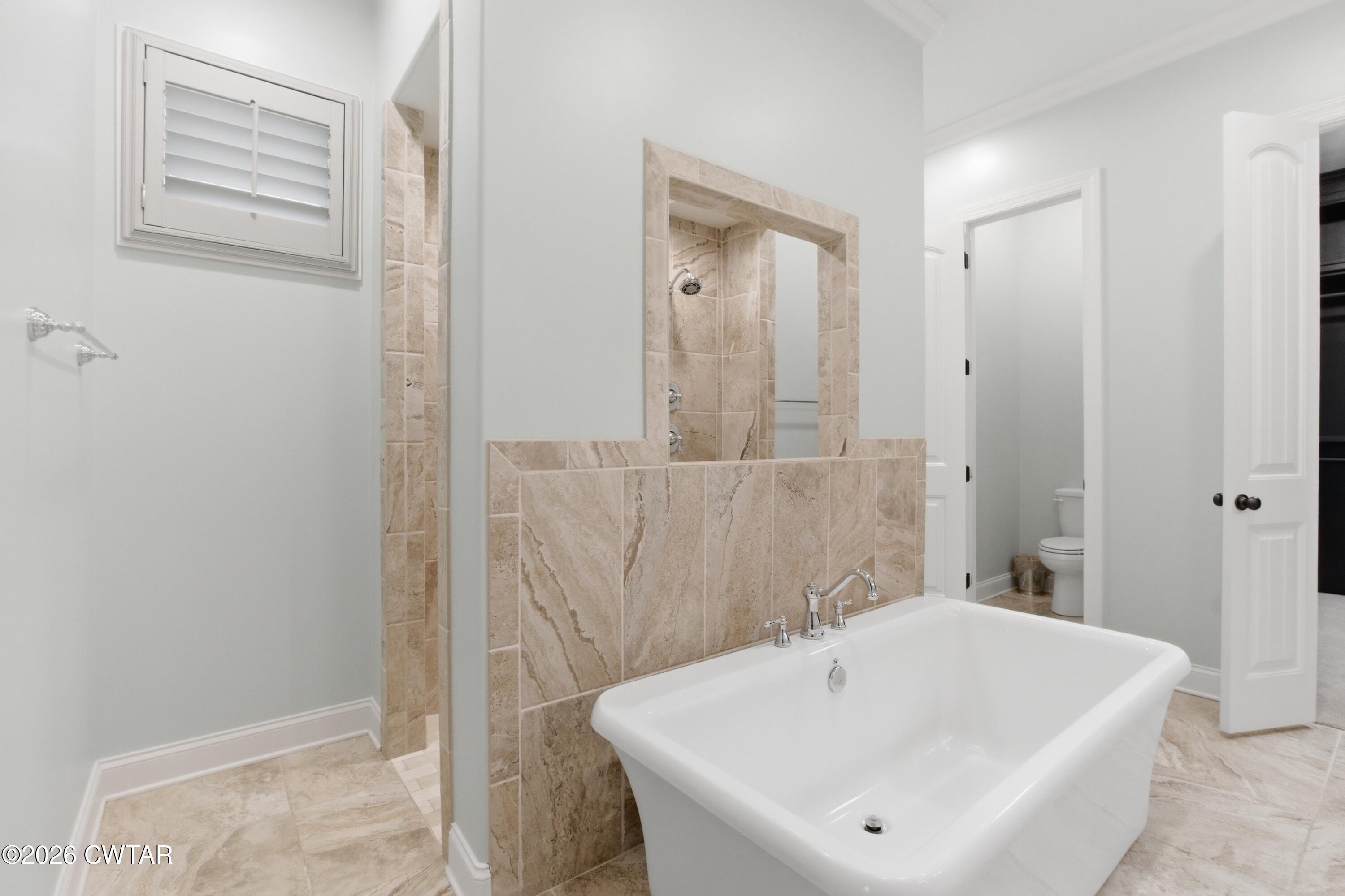 963 Ashport Road Jackson, TN 38305 - Photo 25 of 60 a bathroom with a white tub and shower