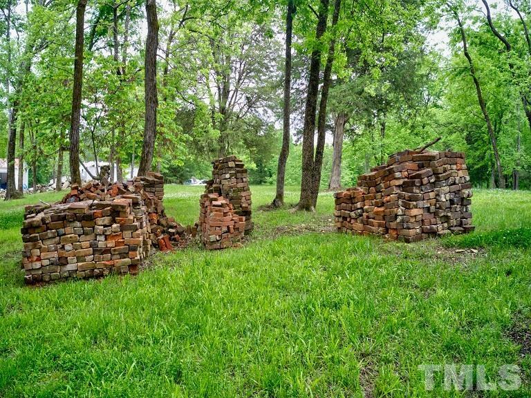 Ivy Hill Road Clarksville, VA 23927 - Photo 7 of 25 a view of a backyard with plants and a large tree
