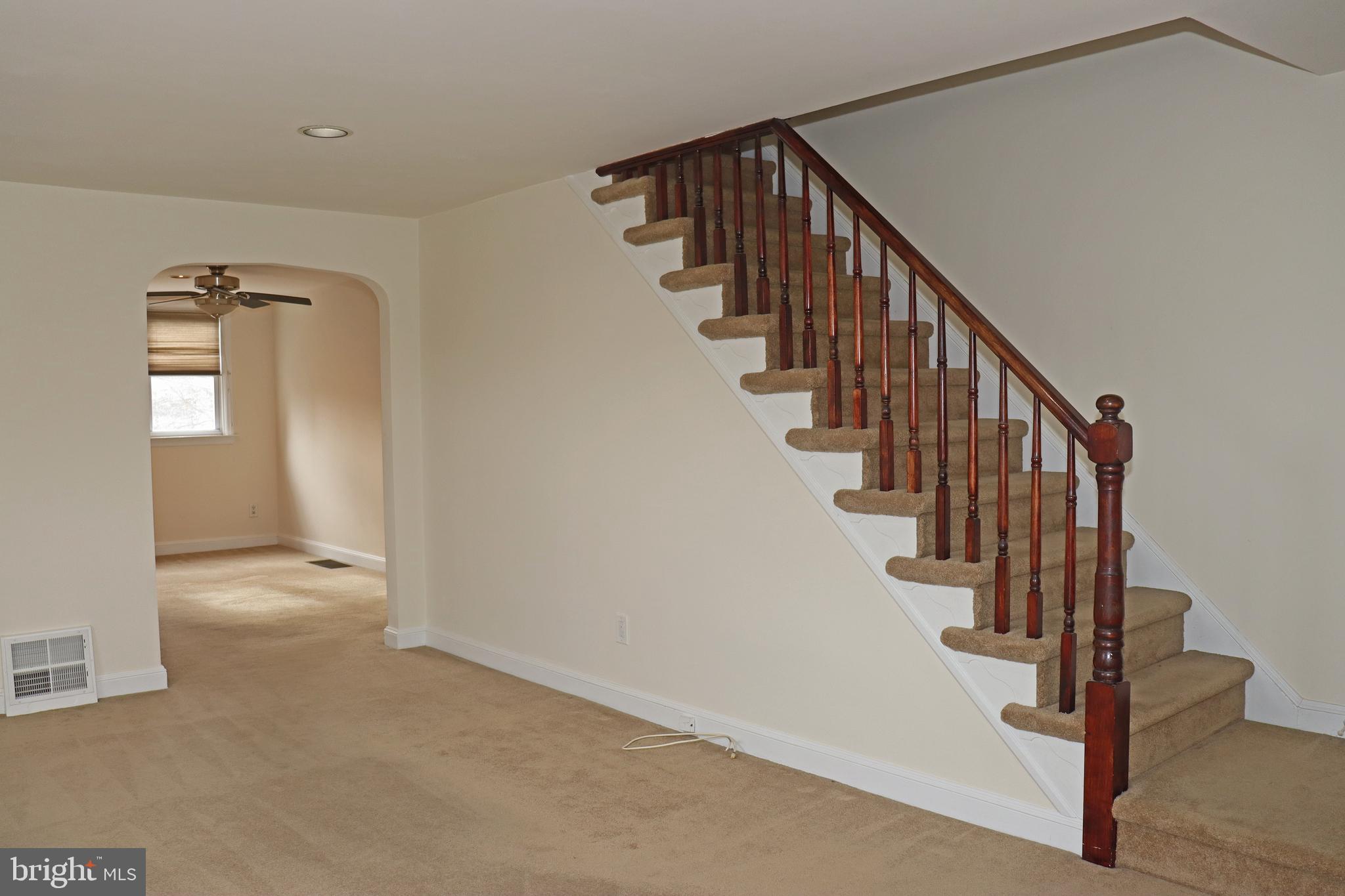 858 Fairfax Road Drexel Hill, PA 19026 - Photo 2 of 20 a view of hallway with stairs and wooden floor