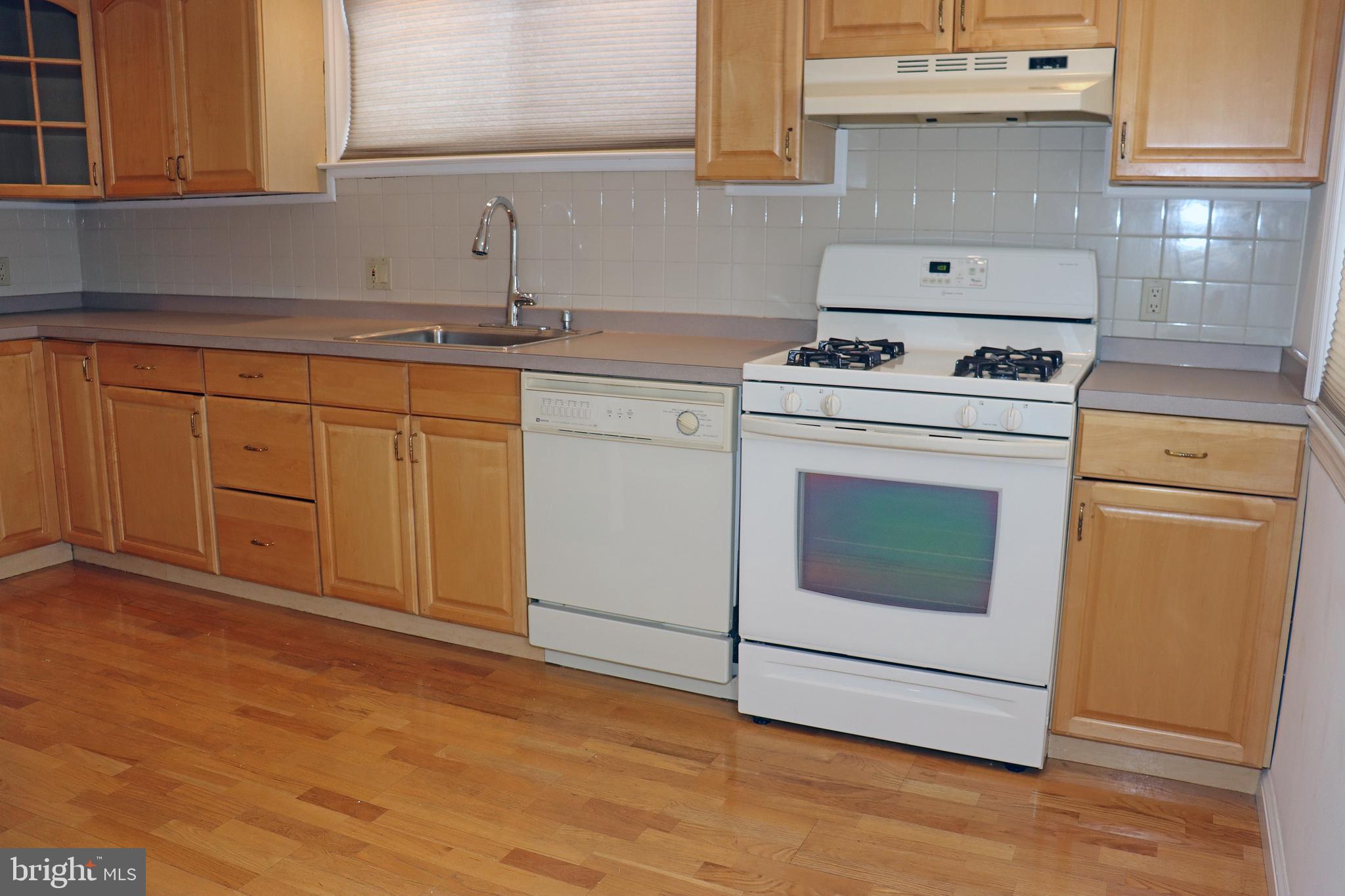 858 Fairfax Road Drexel Hill, PA 19026 - Photo 7 of 20 a kitchen with granite countertop white cabinets and white appliances