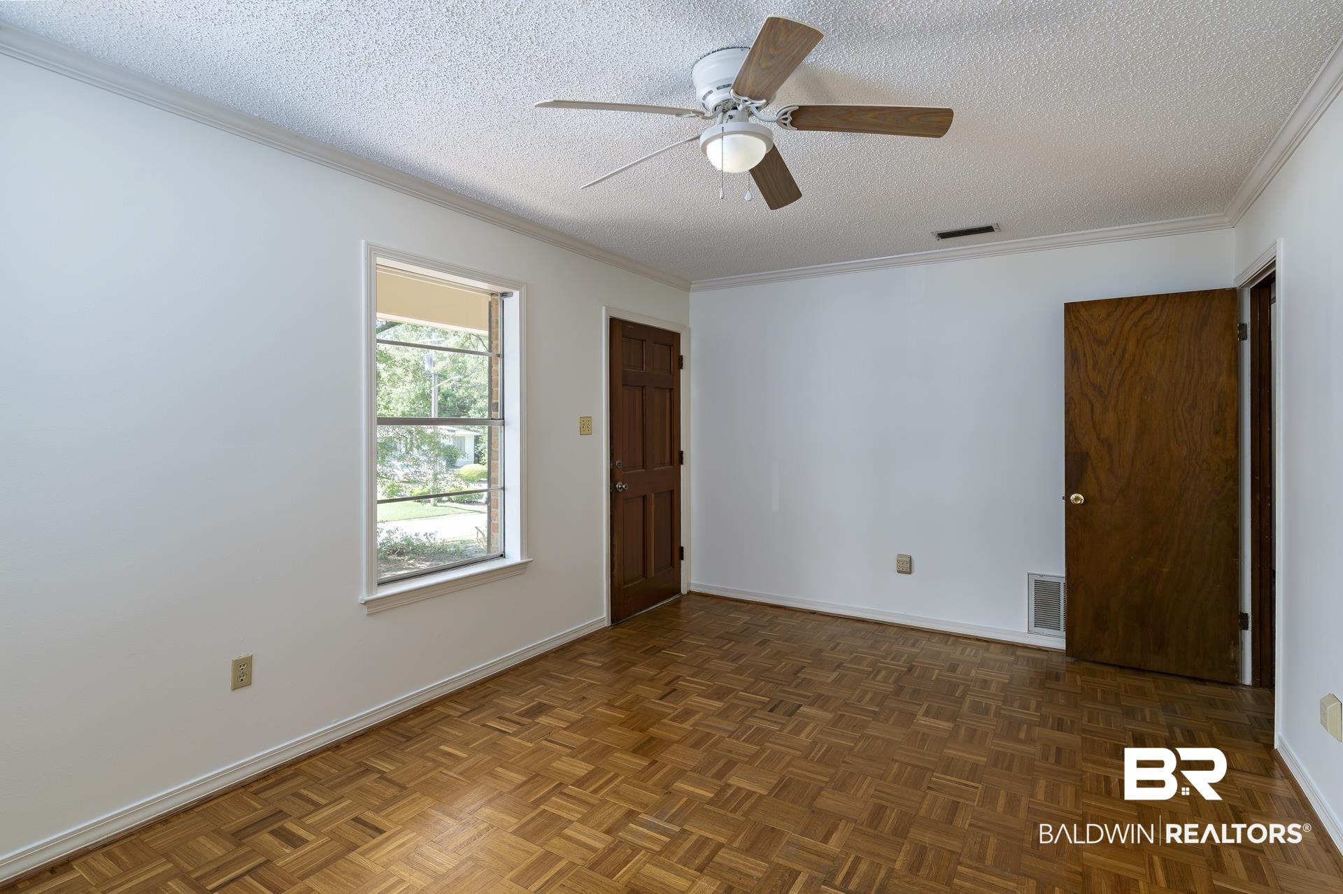 707 Johnson Avenue Fairhope, AL 36532 - Photo 16 of 38 Unfurnished room with a textured ceiling, ceiling fan, and visible vents