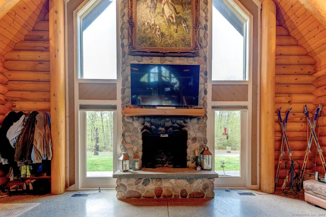 a living room with furniture a fireplace and a window
