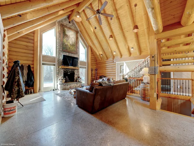a living room with furniture a flat screen tv and a fireplace