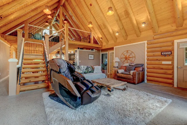 a living room with furniture and a chandelier