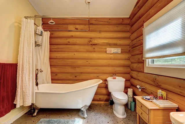 a bathroom with a toilet and shower