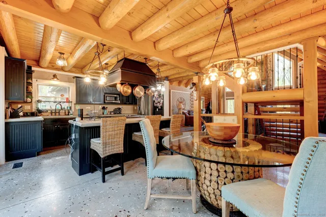 a dining room with furniture and a kitchen view