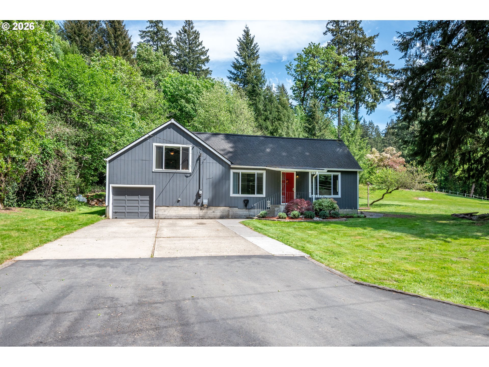 1304 Coal Creek Road Longview, WA 98632 - Photo 23 of 44 a front view of a house with a yard and garage