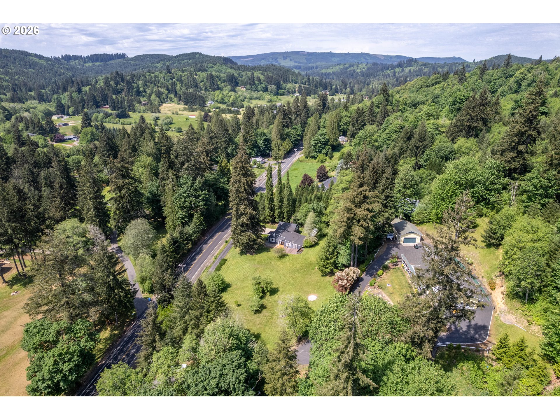 1304 Coal Creek Road Longview, WA 98632 - Photo 40 of 44 a view of a lush green field with a building in the background