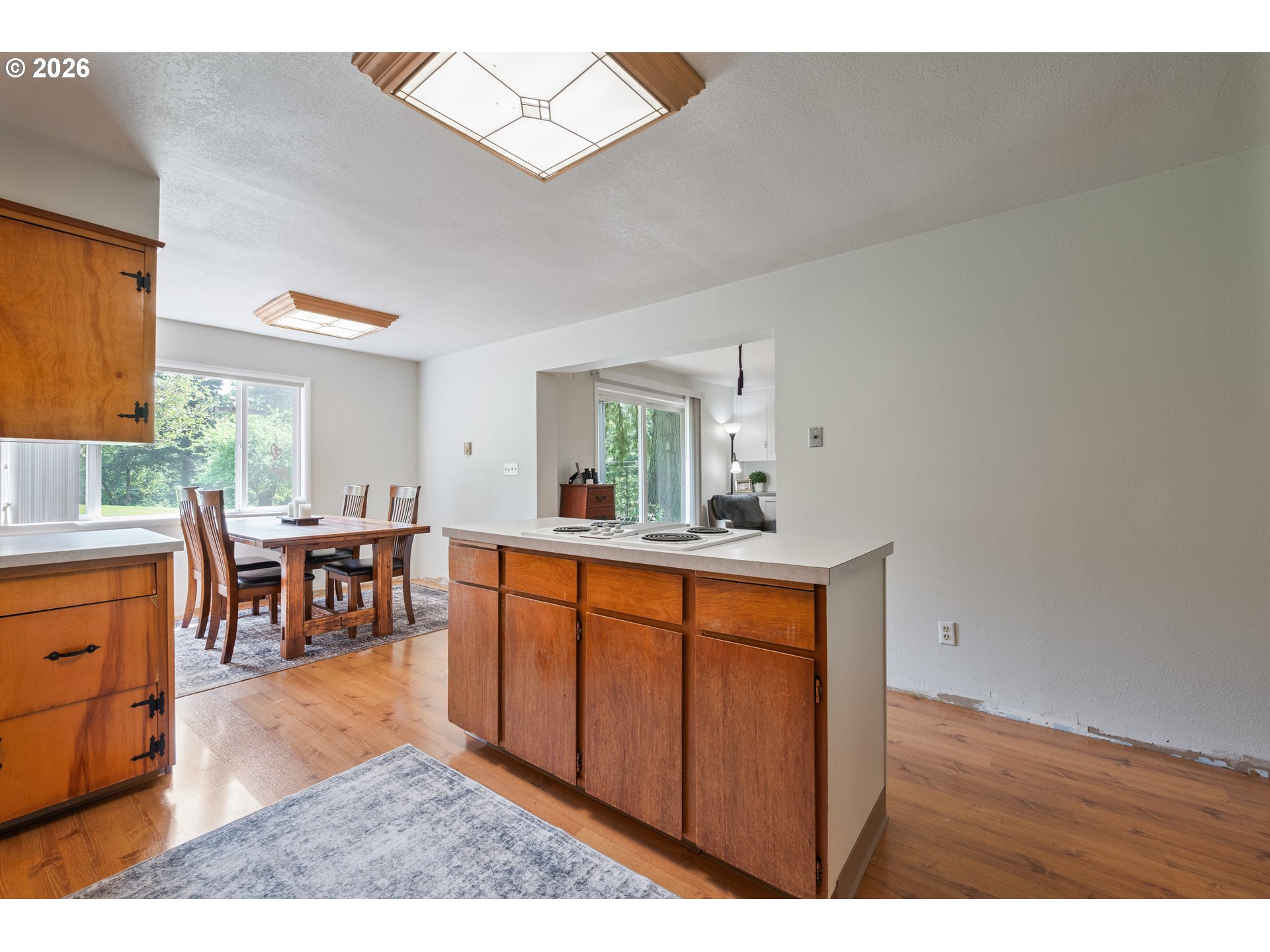 1304 Coal Creek Road Longview, WA 98632 - Photo 5 of 44 a room with furniture a large window and wooden floor