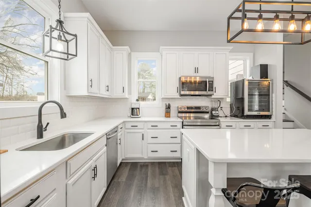 a kitchen with cabinets a sink and appliances