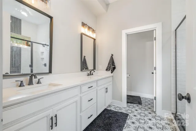 a bathroom with a double vanity sink and a mirror