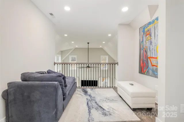 a hallway with a couch and a book shelf