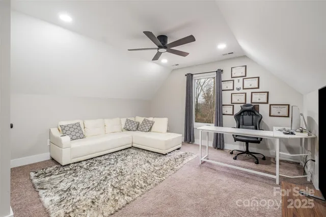 a living room with furniture a rug and a chandelier