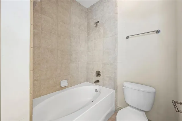 a bathroom with a toilet and a bathtub