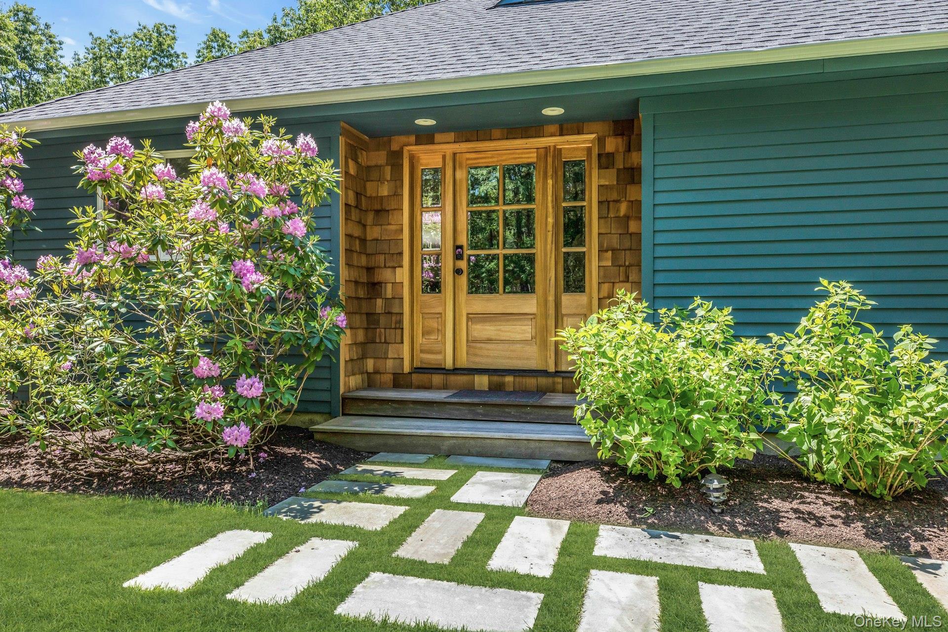 16 Hildreth Road Hampton Bays, NY 11946 - Photo 6 of 29 a front view of a house with garden