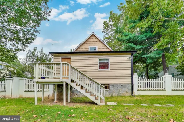 a front view of a house with a yard table and chairs