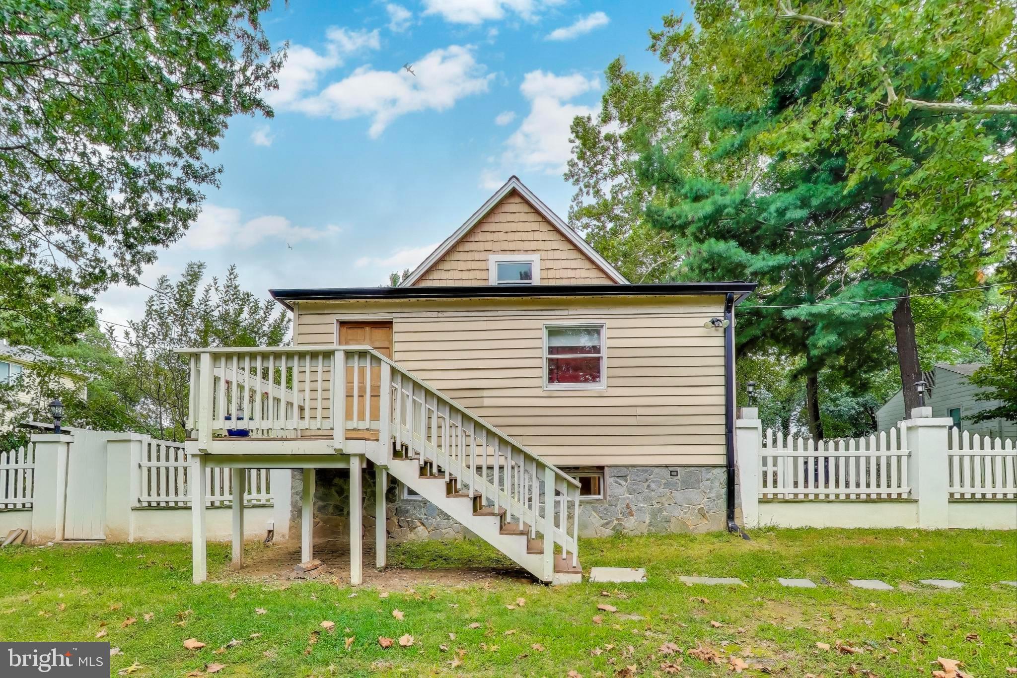 a front view of a house with a yard table and chairs