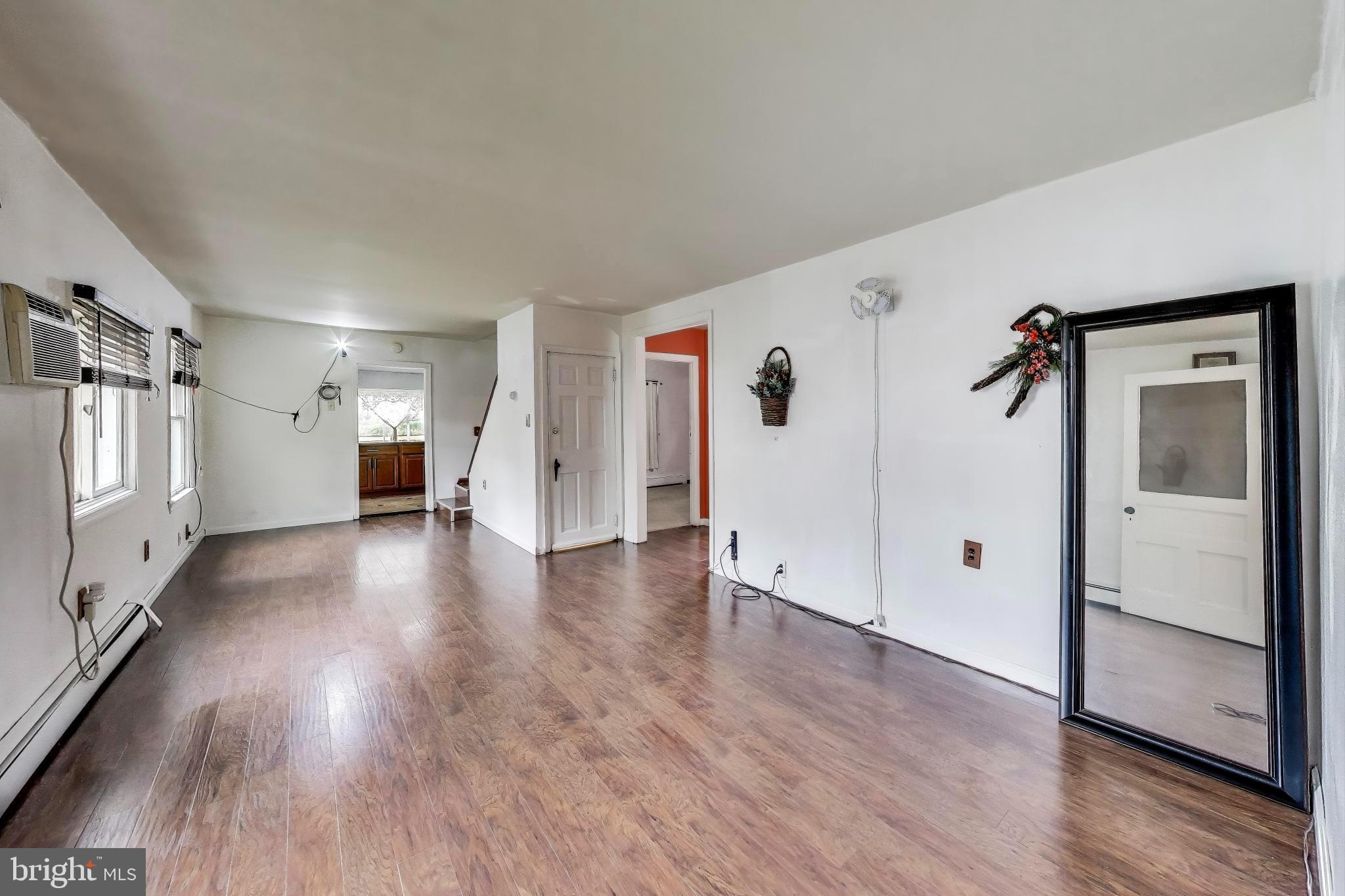 9211 Fowler Lane Lanham, MD 20706 - Photo 11 of 50 a view of a big room with wooden floor and windows