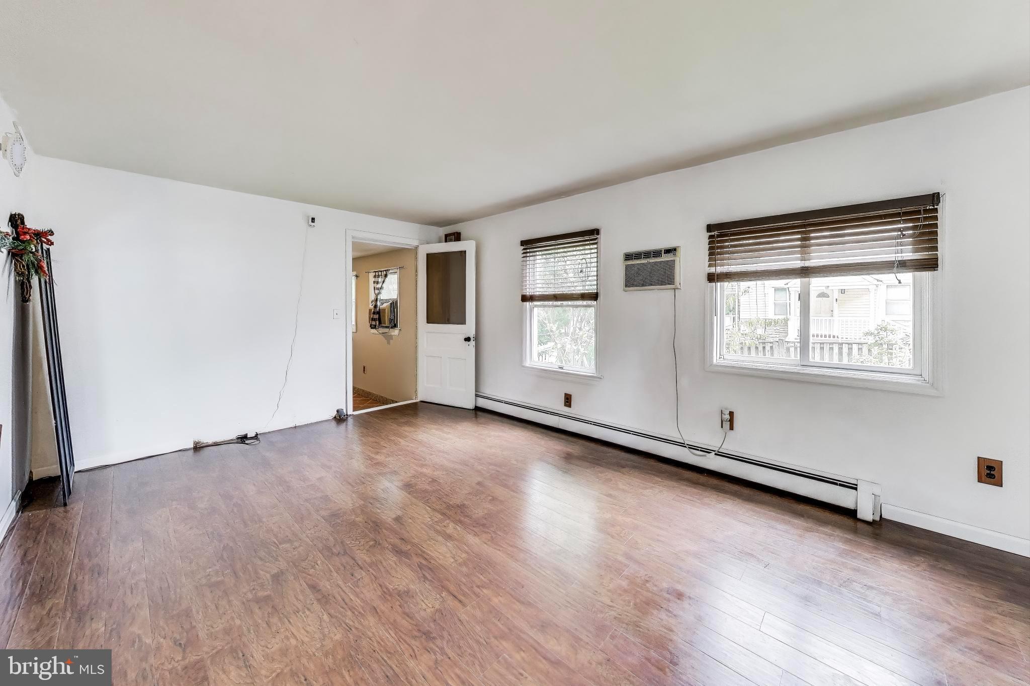 9211 Fowler Lane Lanham, MD 20706 - Photo 12 of 50 an empty room with wooden floor and windows