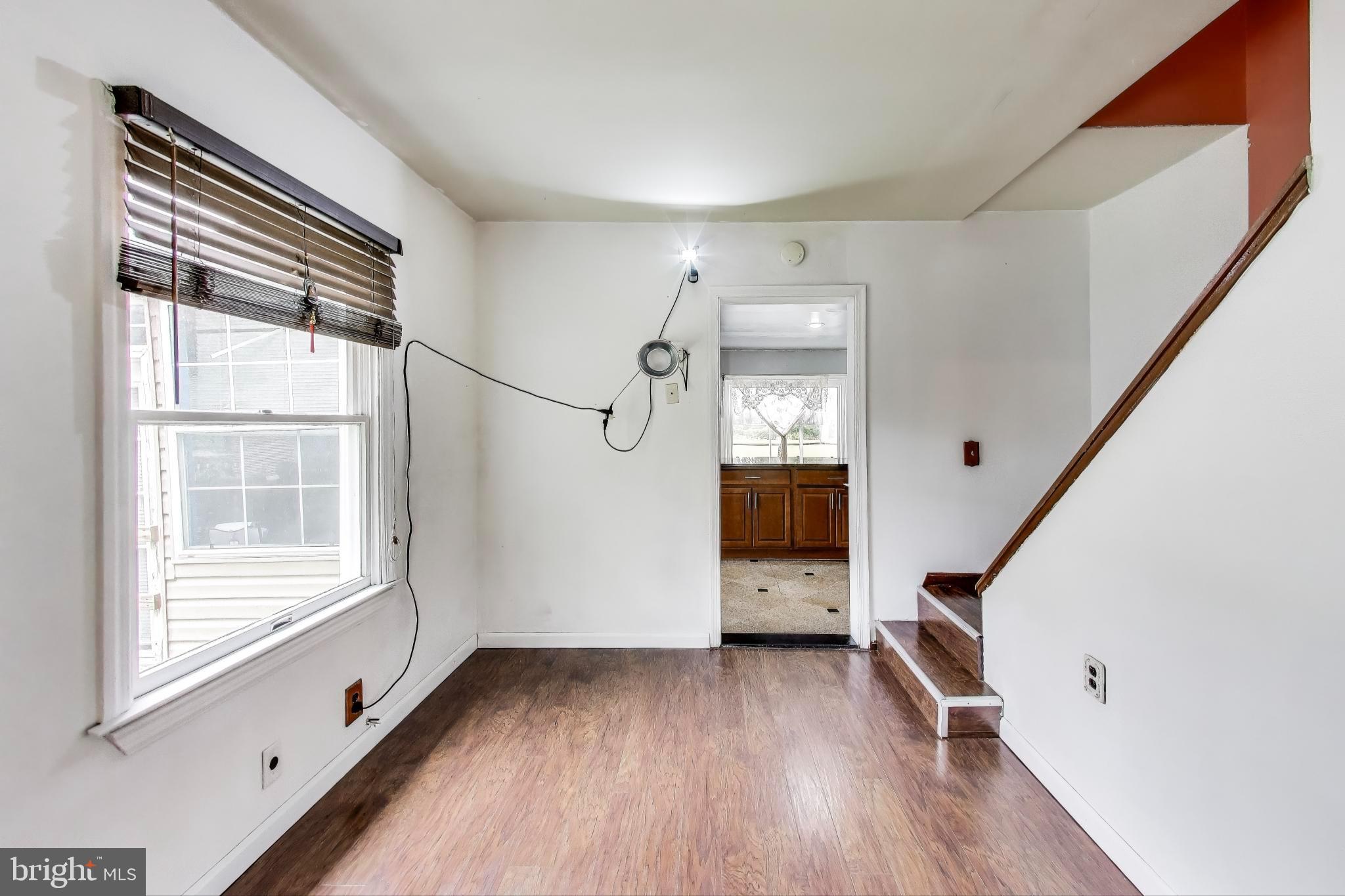 9211 Fowler Lane Lanham, MD 20706 - Photo 13 of 50 a view of an empty room with a window and wooden floor