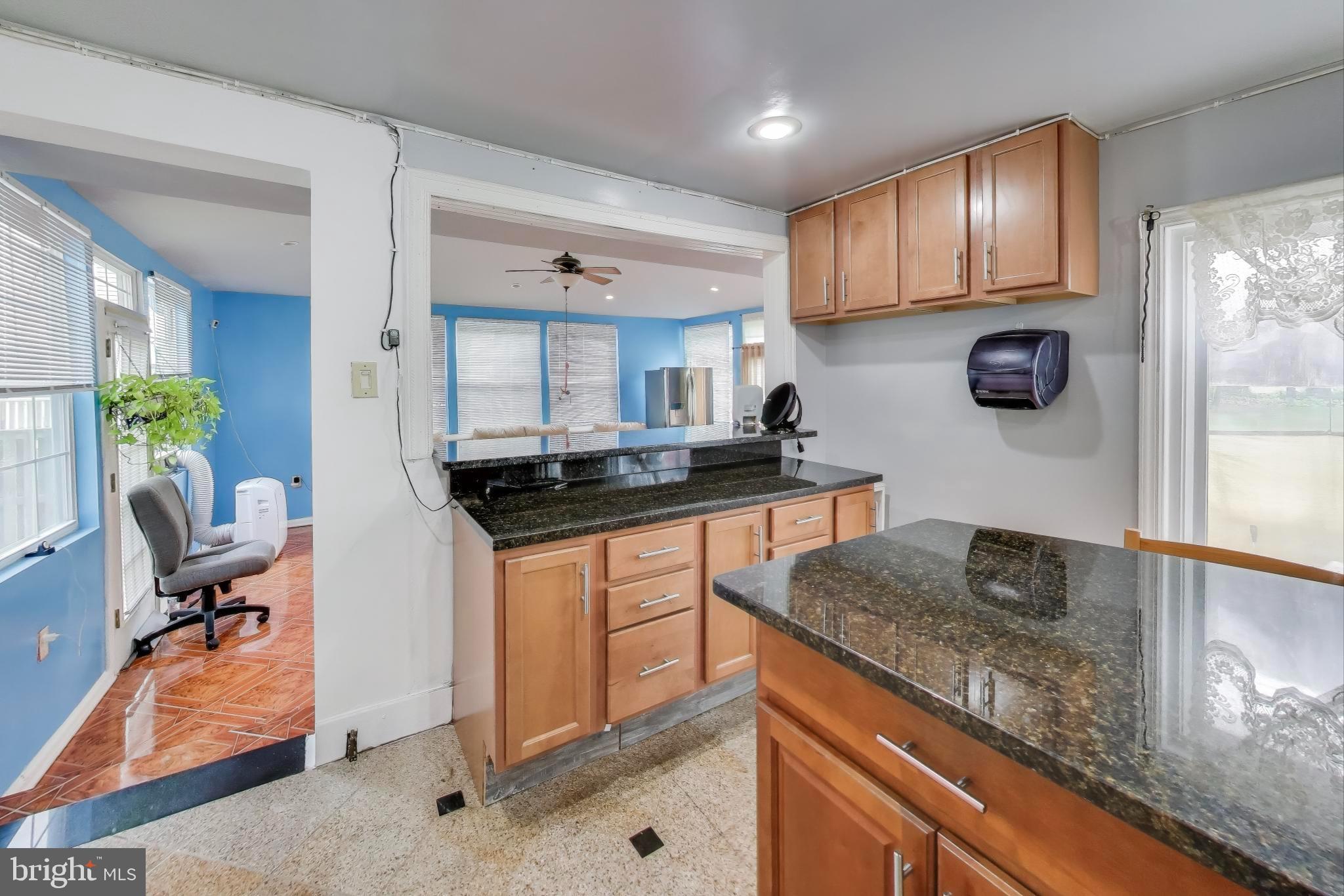 9211 Fowler Lane Lanham, MD 20706 - Photo 16 of 50 a kitchen with stainless steel appliances granite countertop a sink stove and cabinets