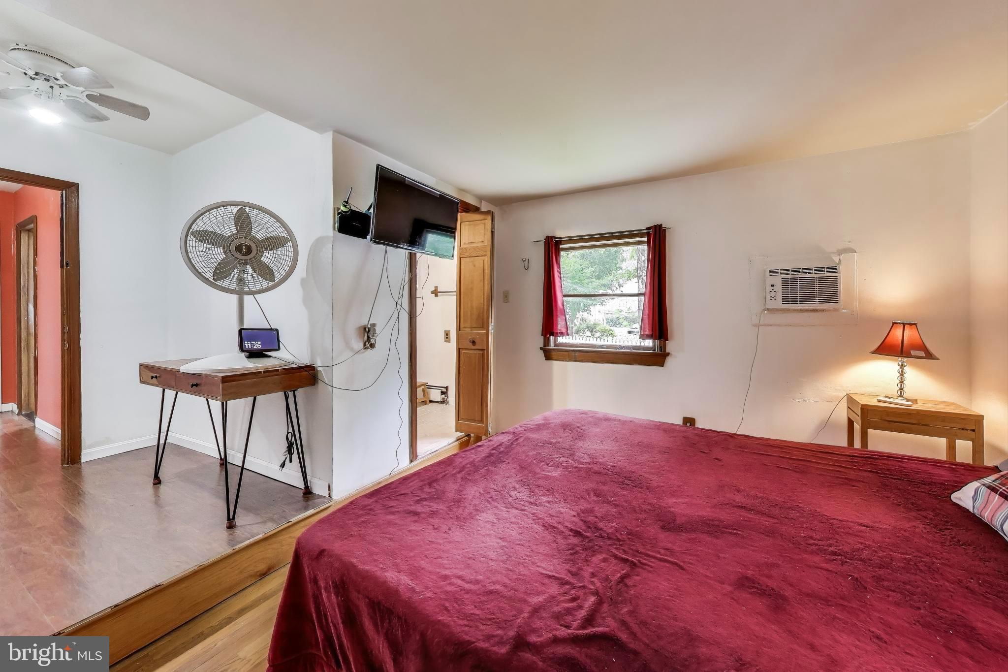 9211 Fowler Lane Lanham, MD 20706 - Photo 18 of 50 a bedroom with a bed and a table in it