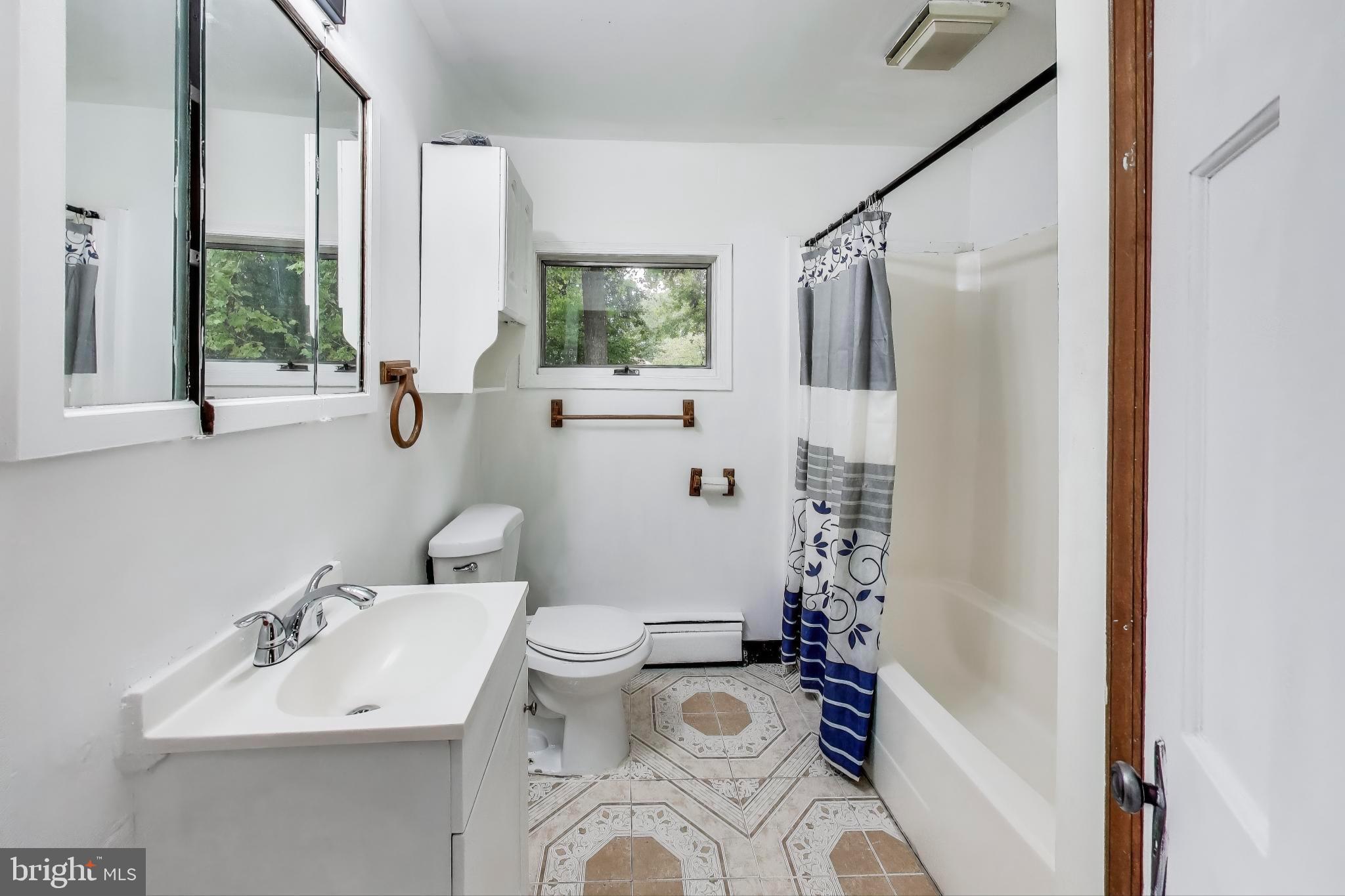 9211 Fowler Lane Lanham, MD 20706 - Photo 23 of 50 a bathroom with a sink toilet and shower