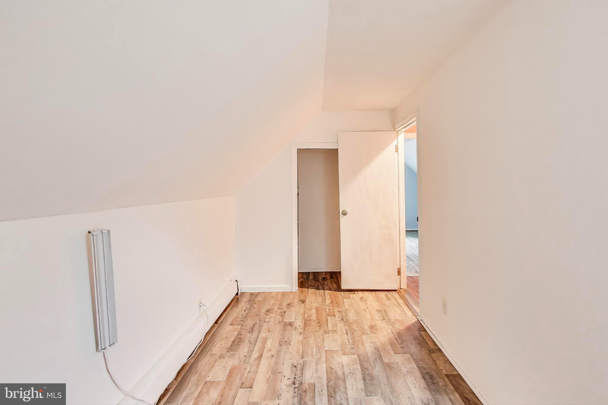 9211 Fowler Lane Lanham, MD 20706 - Photo 27 of 50 a view of a room with wooden floor and white walls