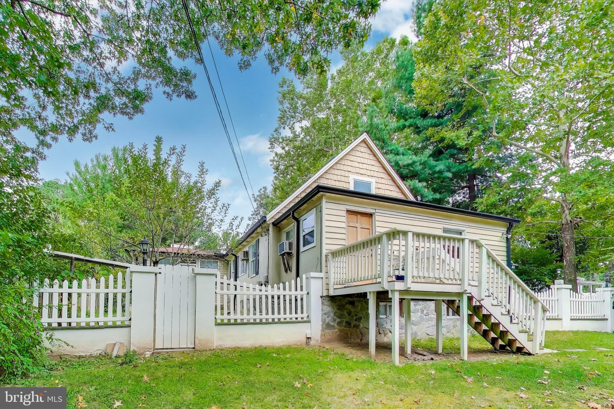 9211 Fowler Lane Lanham, MD 20706 - Photo 3 of 50 a view of a white house with a big yard and large trees