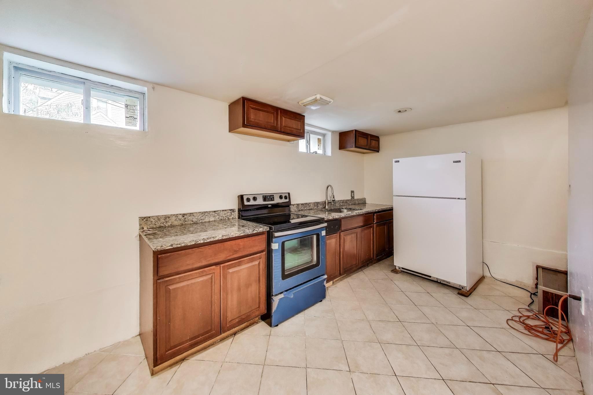 9211 Fowler Lane Lanham, MD 20706 - Photo 31 of 50 a kitchen with stainless steel appliances granite countertop a stove a refrigerator and a refrigerator
