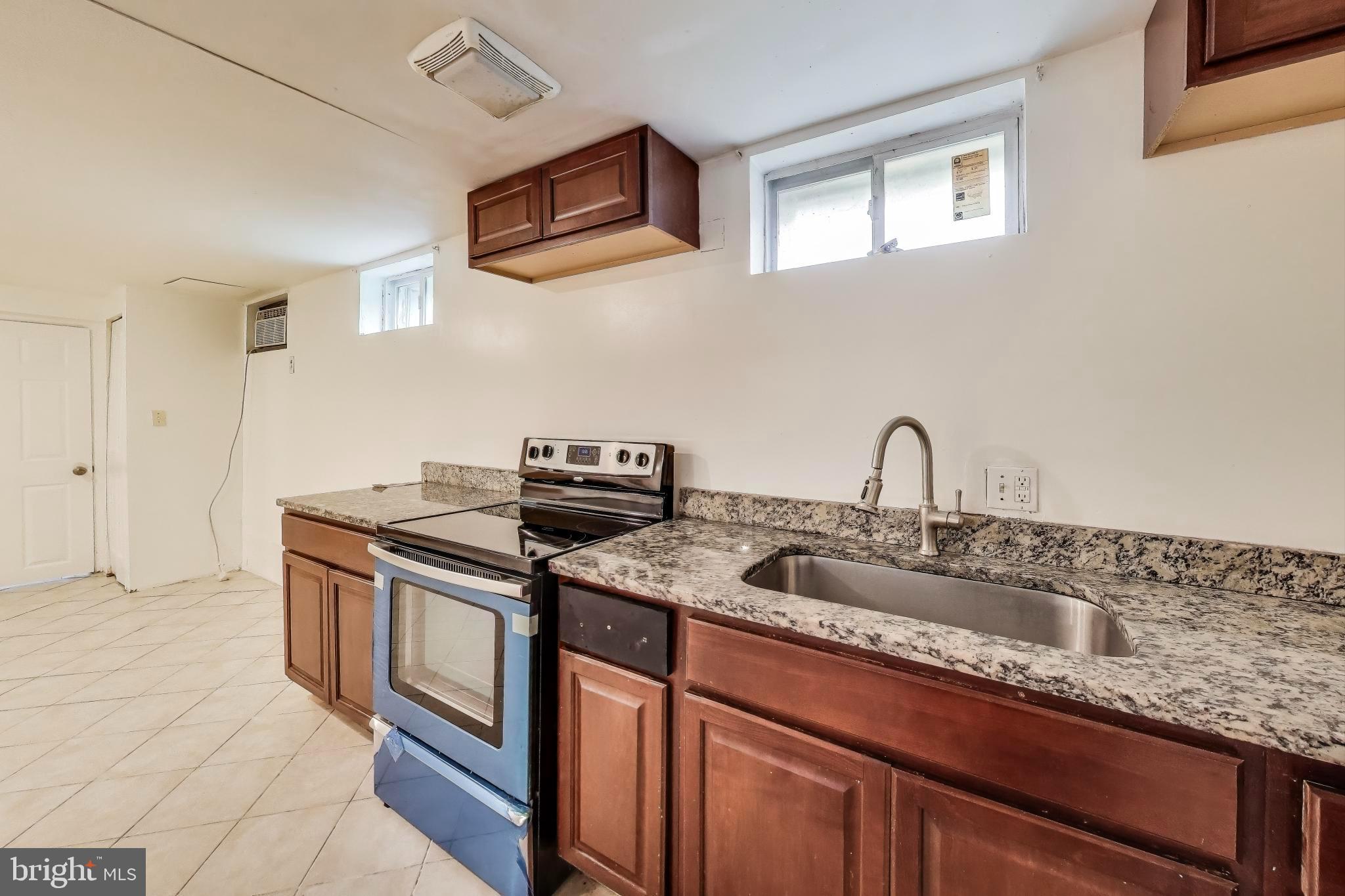 9211 Fowler Lane Lanham, MD 20706 - Photo 32 of 50 a kitchen with stainless steel appliances granite countertop a sink stove and cabinets