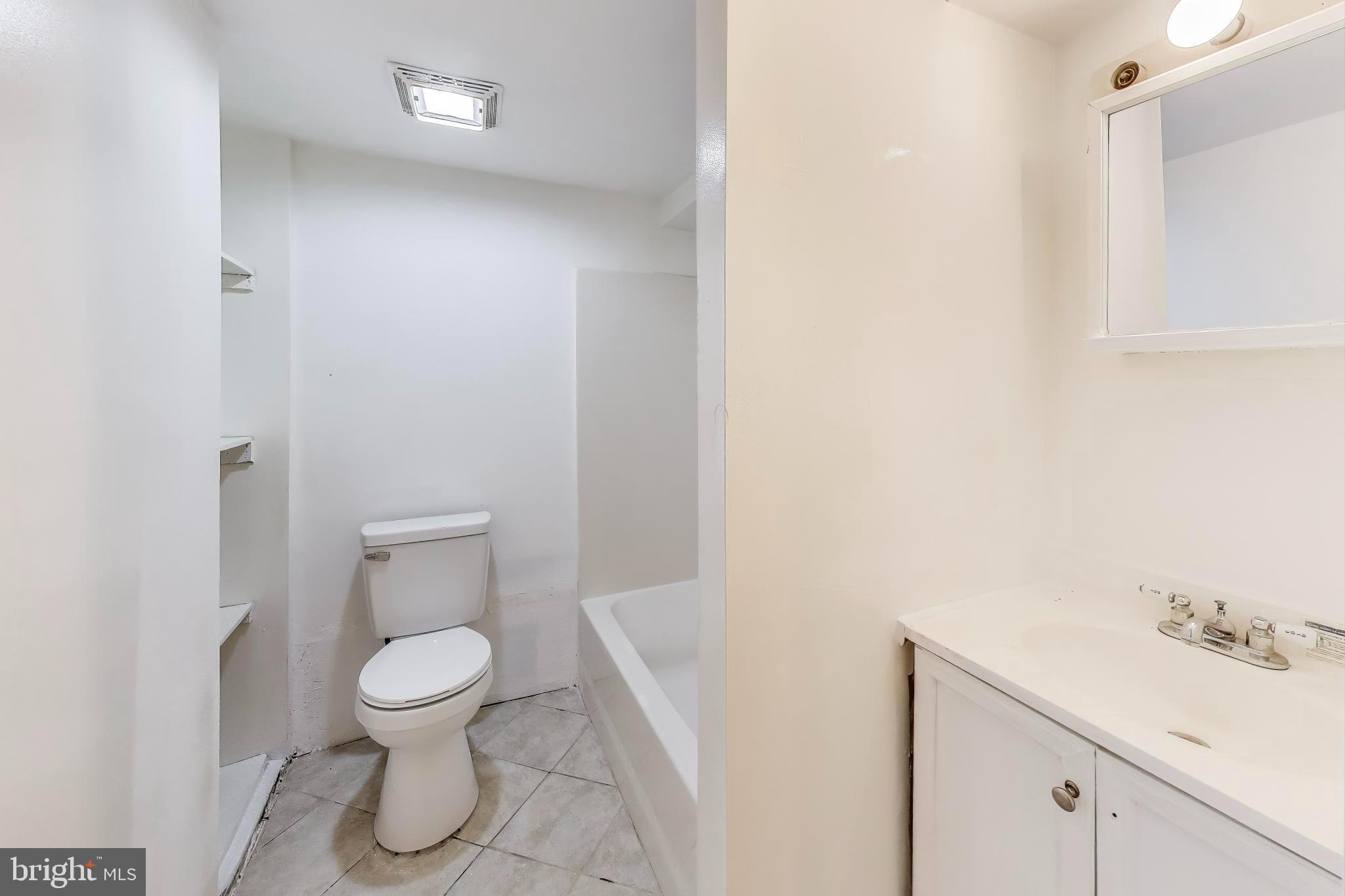 9211 Fowler Lane Lanham, MD 20706 - Photo 37 of 50 a white toilet sitting next to a bathroom sink