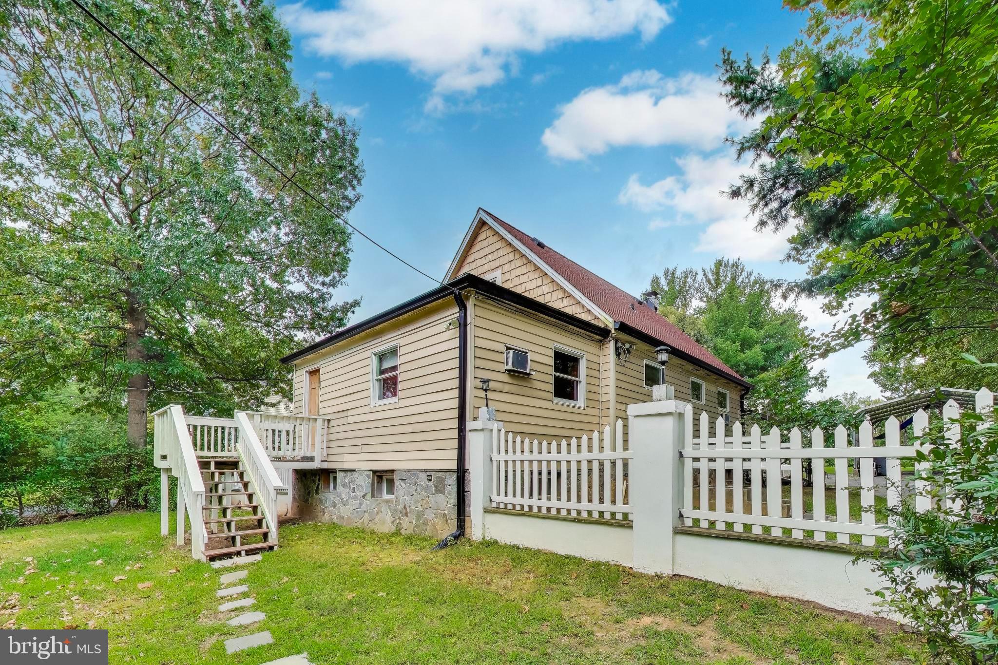 9211 Fowler Lane Lanham, MD 20706 - Photo 4 of 50 a front view of a house with a garden