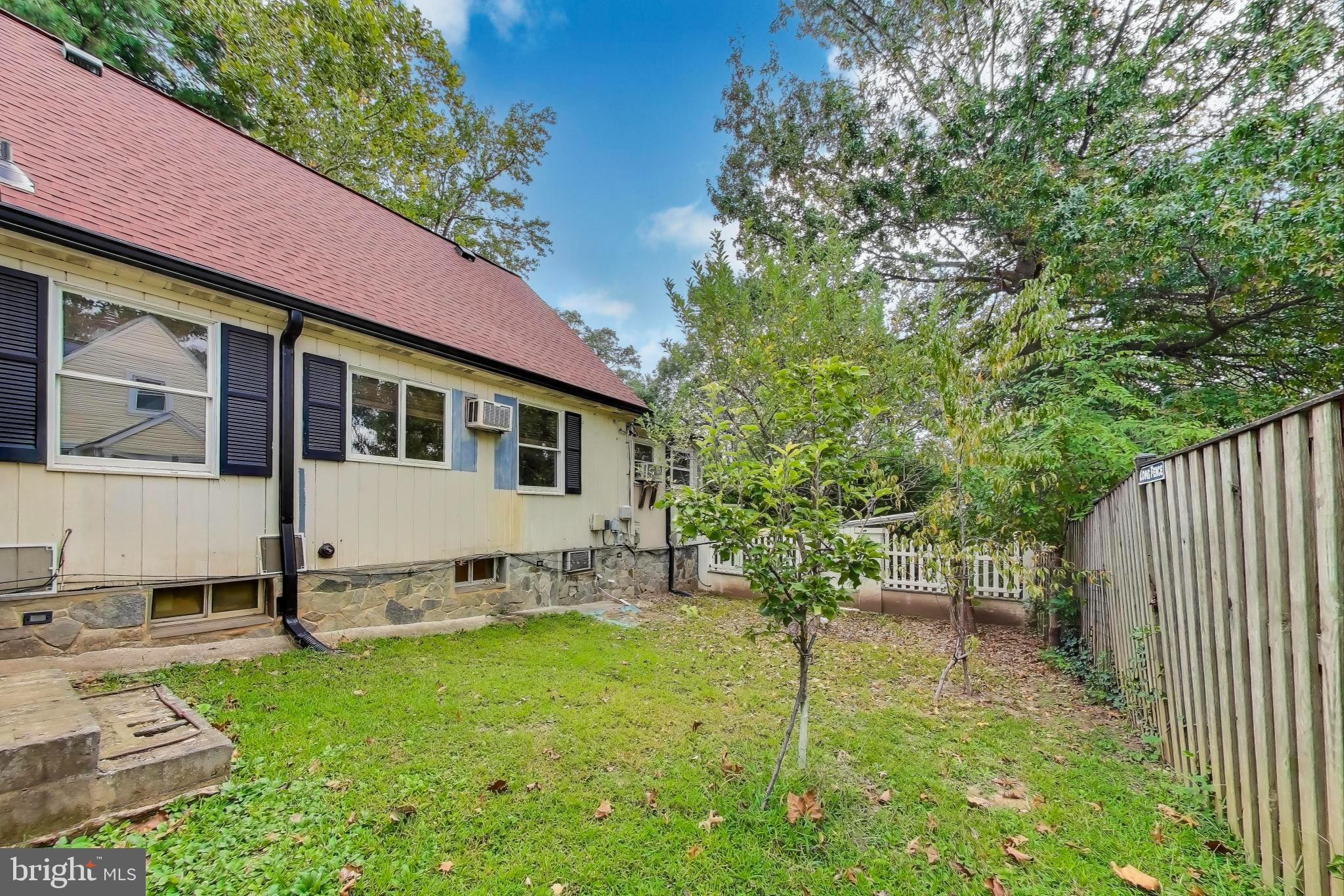 9211 Fowler Lane Lanham, MD 20706 - Photo 45 of 50 a view of a white house with a yard