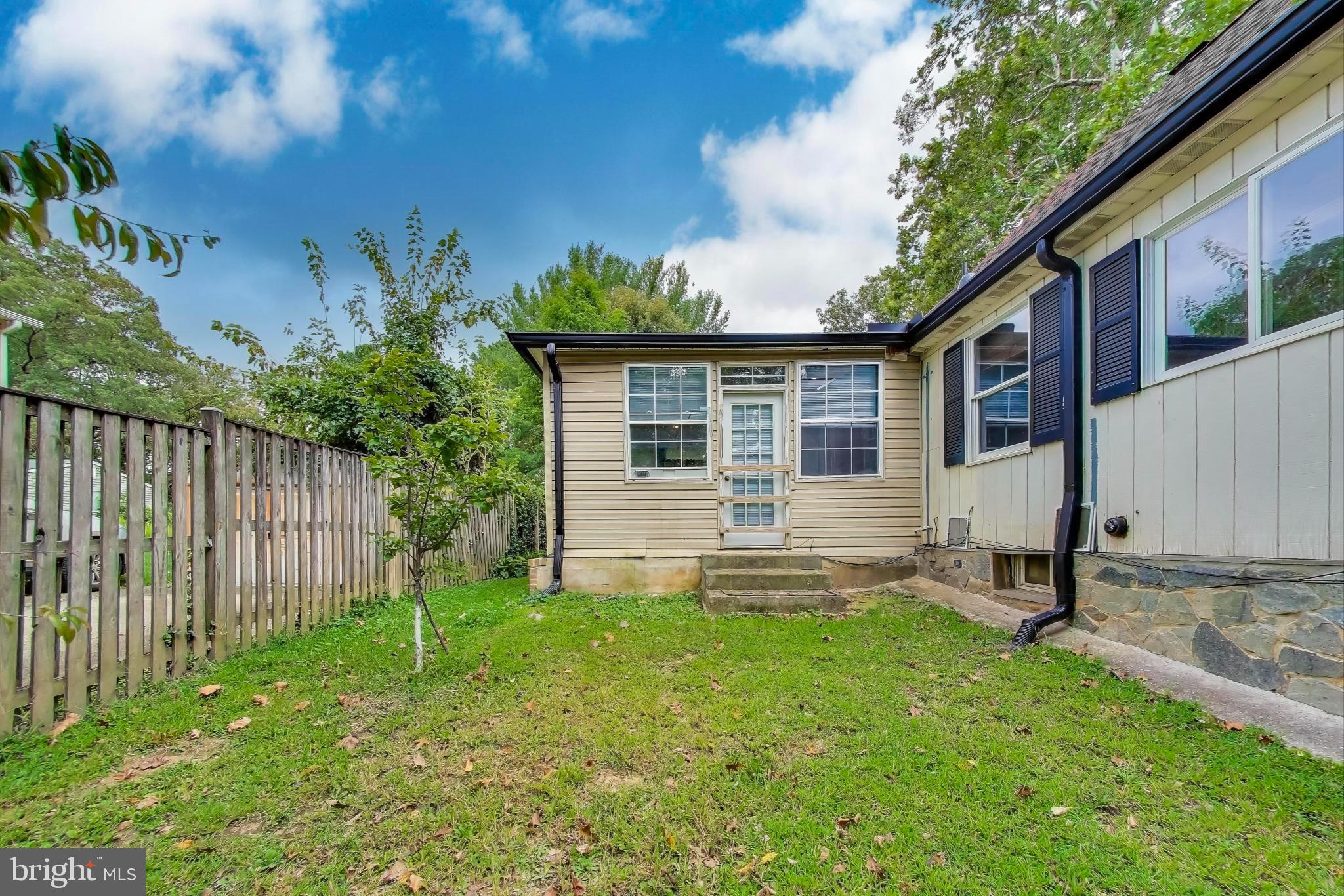 9211 Fowler Lane Lanham, MD 20706 - Photo 46 of 50 a backyard of a house with potted plants and wooden fence