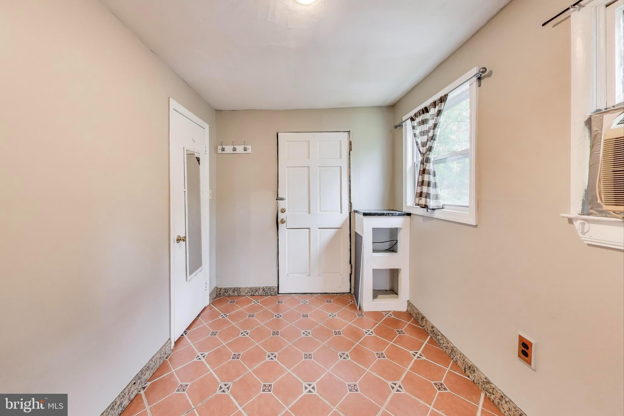 9211 Fowler Lane Lanham, MD 20706 - Photo 8 of 50 a view of empty room with a fireplace and windows