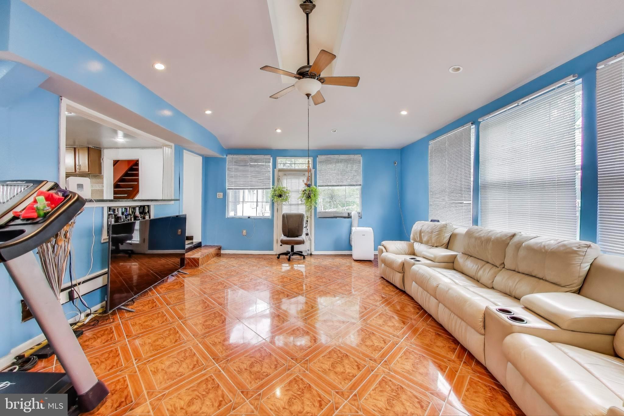 9211 Fowler Lane Lanham, MD 20706 - Photo 9 of 50 a living room with furniture a fireplace and a flat screen tv