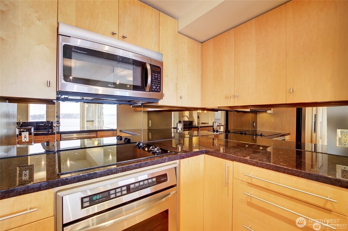 1415 2nd Avenue, Unit 1209 Seattle, WA 98101 - Photo 11 of 21 a kitchen with a stove and a microwave