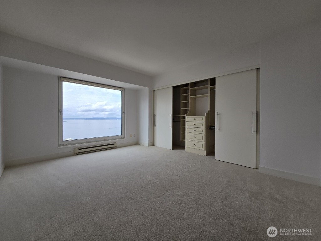 1415 2nd Avenue, Unit 1209 Seattle, WA 98101 - Photo 13 of 21 a view of an empty room with a window