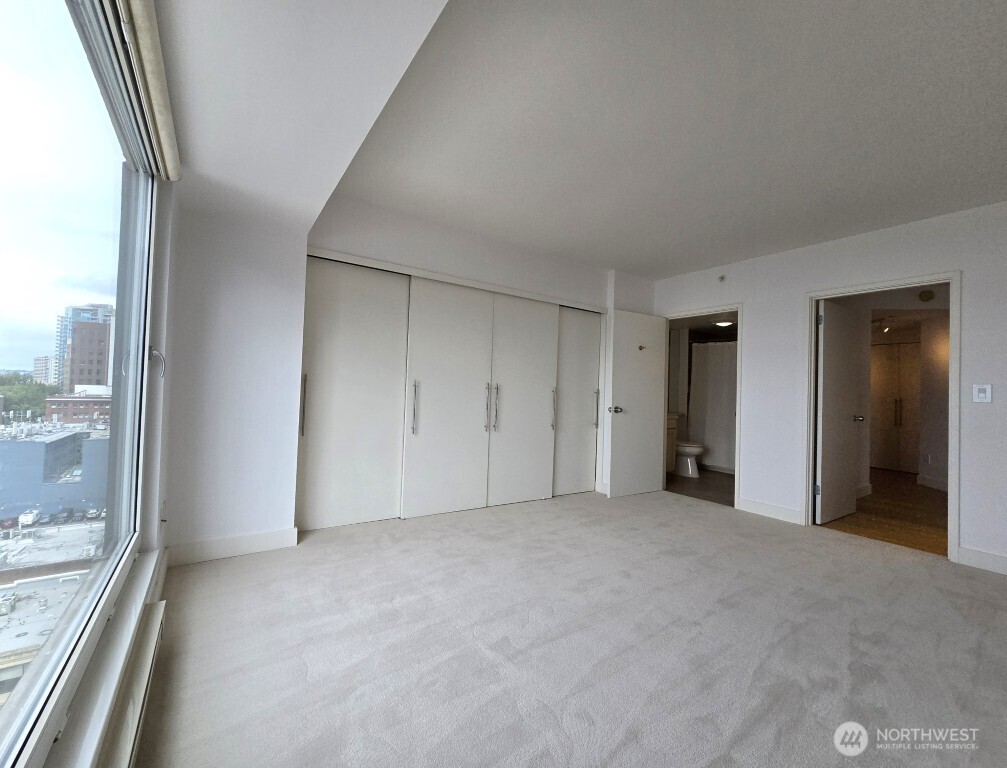 1415 2nd Avenue, Unit 1209 Seattle, WA 98101 - Photo 14 of 21 a view of an empty room with a window