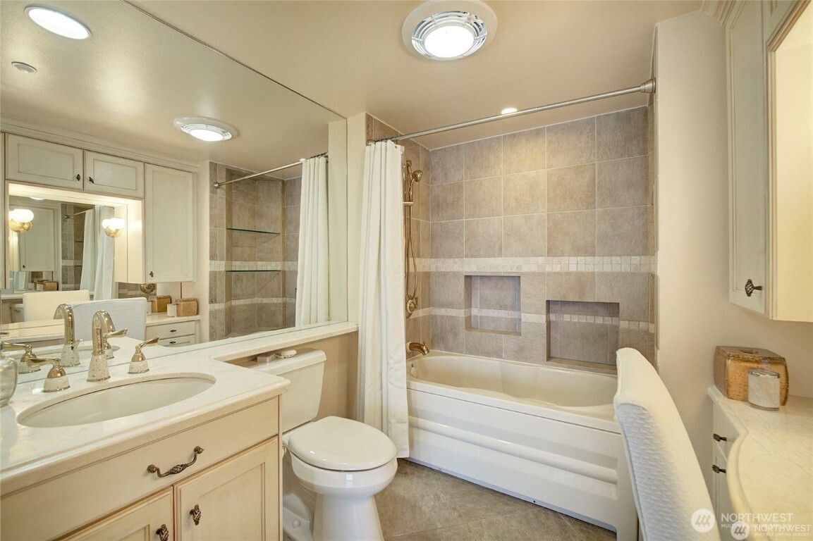 1415 2nd Avenue, Unit 1209 Seattle, WA 98101 - Photo 15 of 21 a bathroom with a sink mirror toilet and bathtub