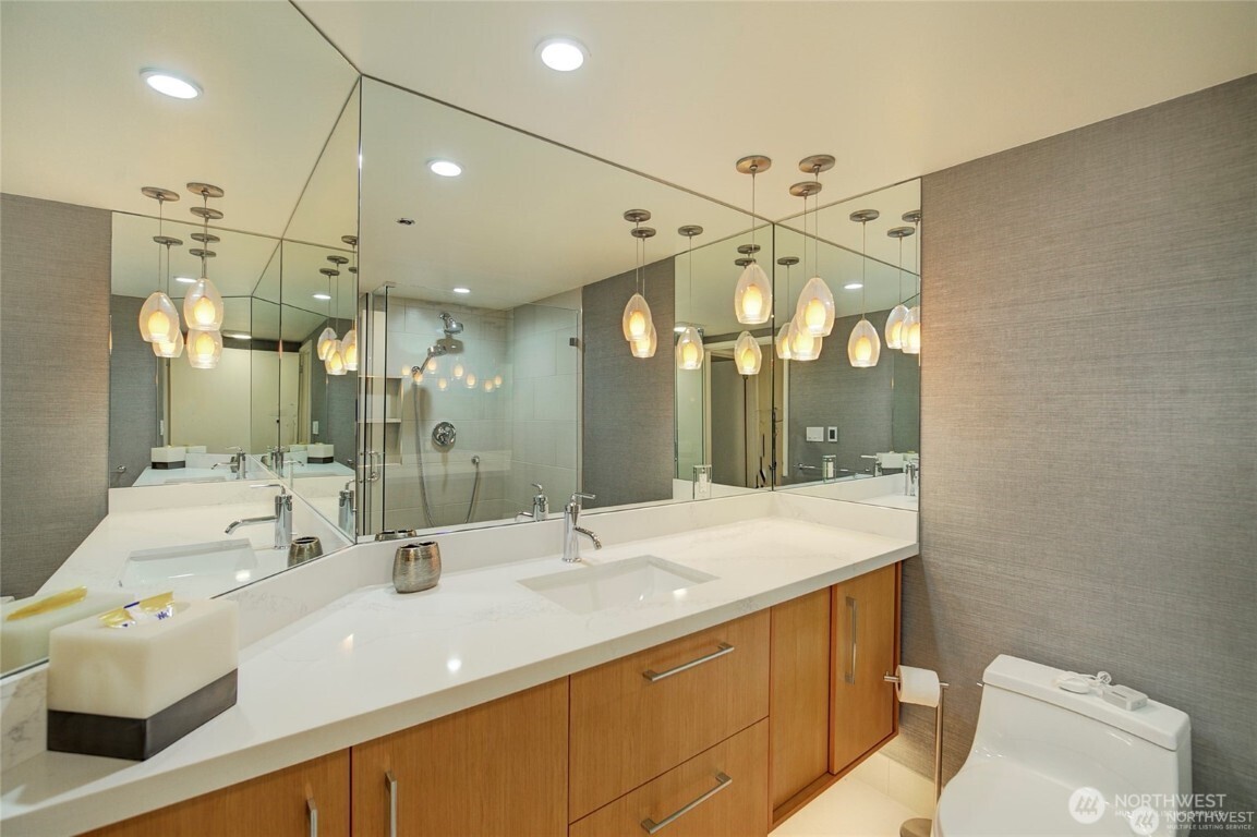 1415 2nd Avenue, Unit 1209 Seattle, WA 98101 - Photo 2 of 21 a bathroom with a sink double vanity and a shower