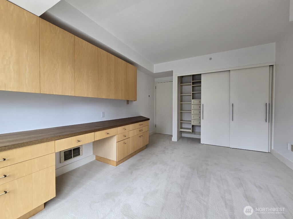 1415 2nd Avenue, Unit 1209 Seattle, WA 98101 - Photo 5 of 21 a view of an empty room with a kitchen
