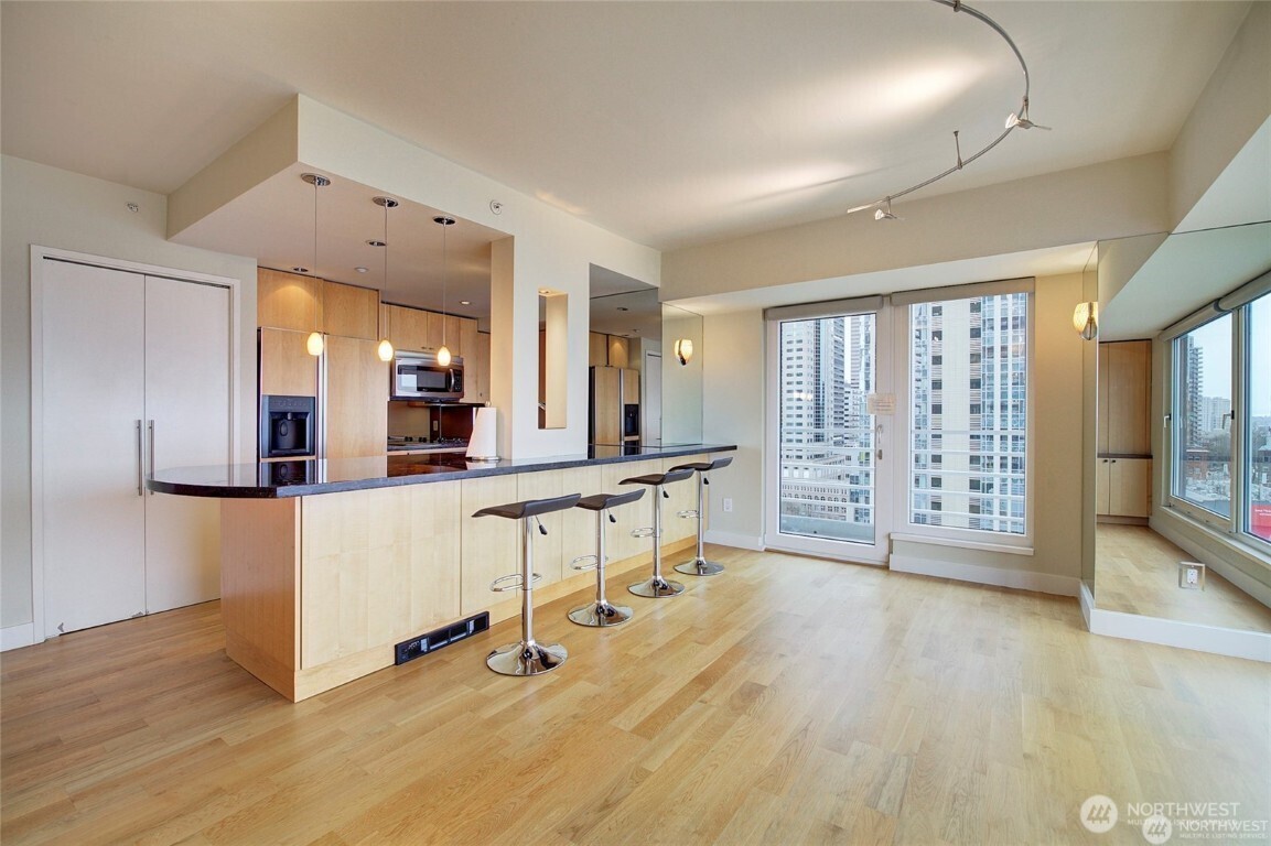 1415 2nd Avenue, Unit 1209 Seattle, WA 98101 - Photo 7 of 21 a view of a kitchen with furniture and a table