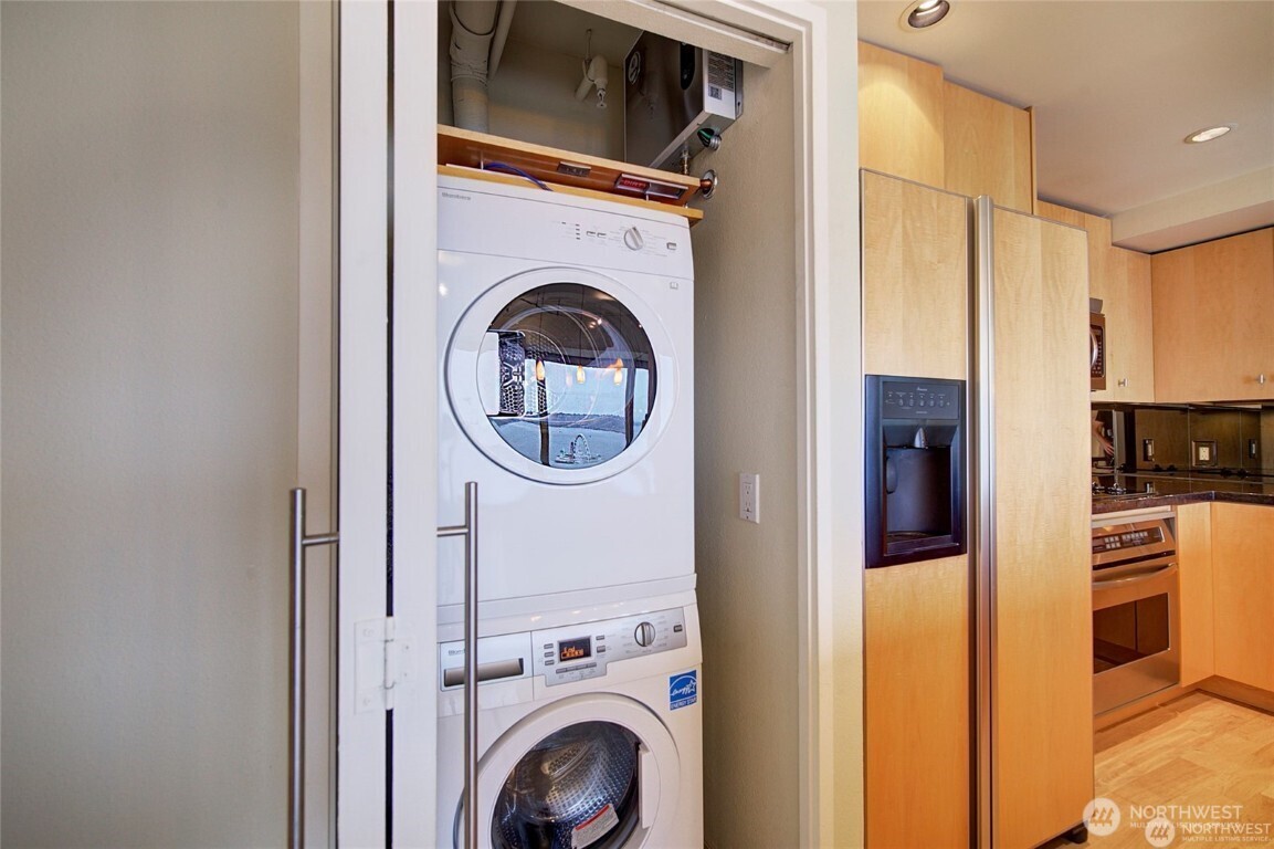 1415 2nd Avenue, Unit 1209 Seattle, WA 98101 - Photo 10 of 21 a view of a kitchen with washer and dryer