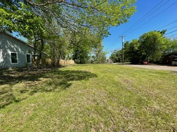 a view of a field with trees in front of it
